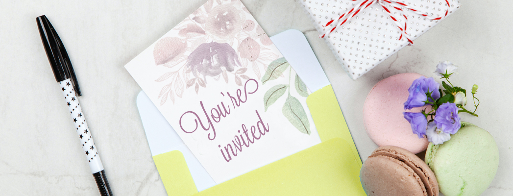 pretty floral invitation pulled out of lime green envelope